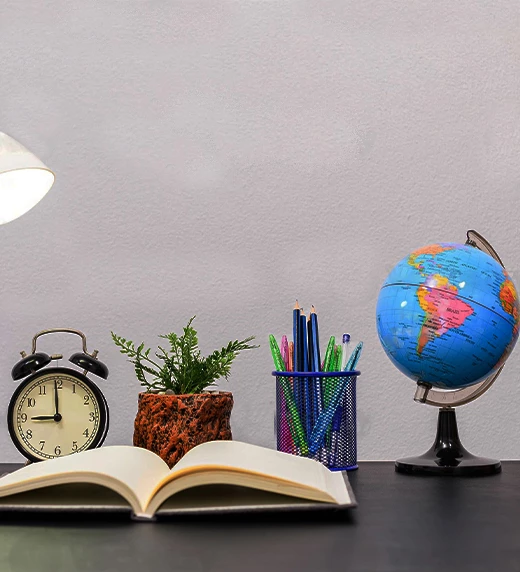 office stationery globe and book on table